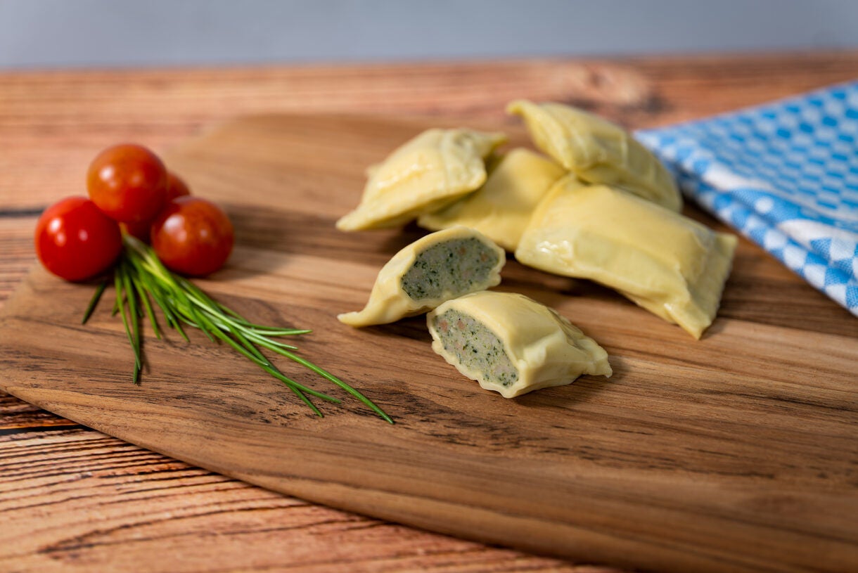 Ravioli on Wooden Board with Cherry Tomatoes