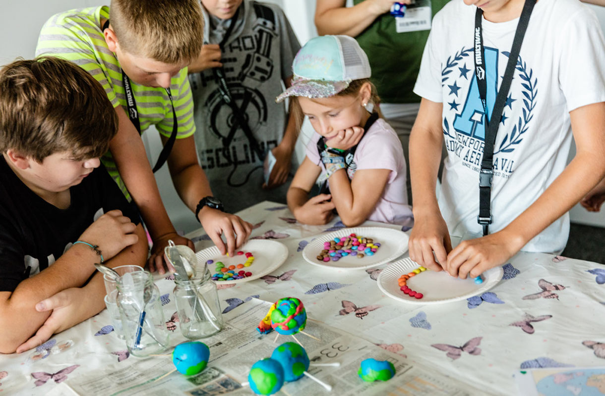Children Crafting Colorful Beads at Workshop